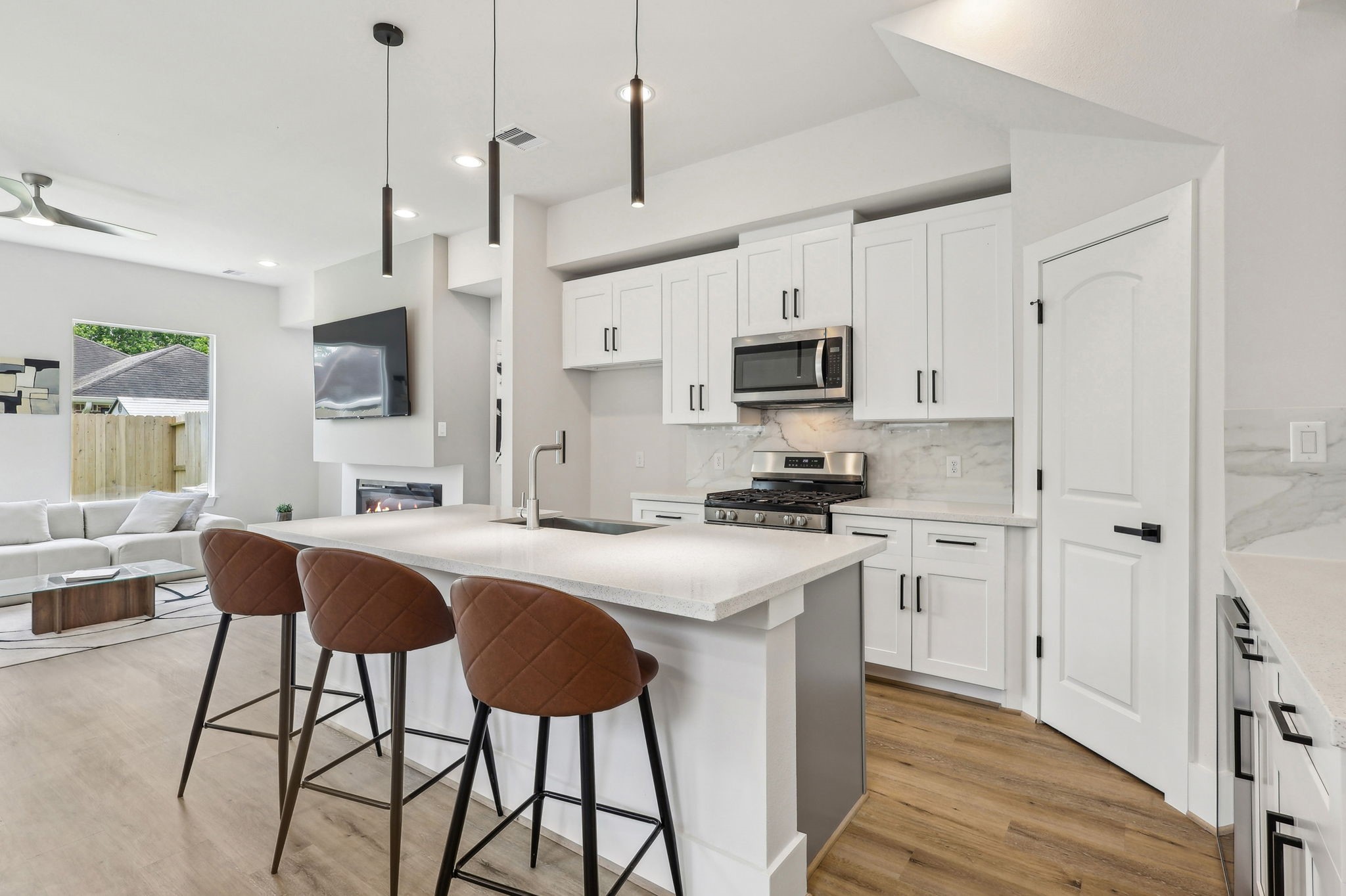 3722 Nathaniel Brown Street Houston, TX 77021 - Photo 10 of 30 a kitchen with stainless steel appliances granite countertop a sink a stove a refrigerator cabinets and chairs