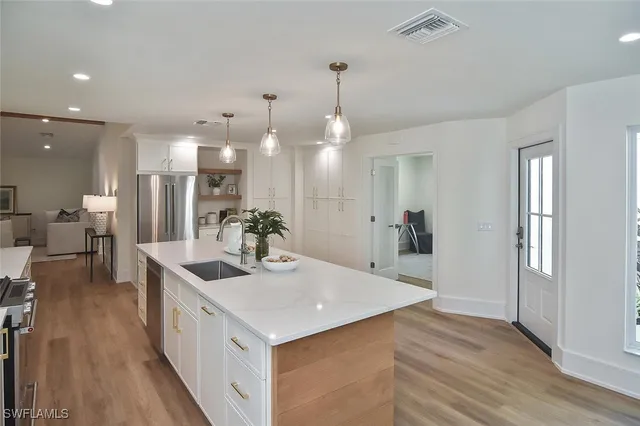 a living room with furniture a fireplace and a potted plant