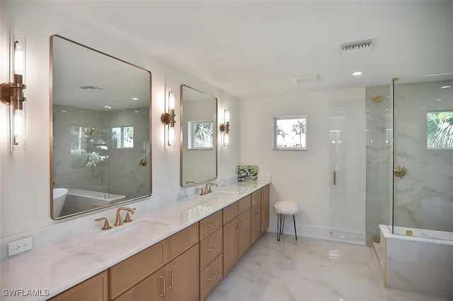 a bathroom with a sink shower and a mirror