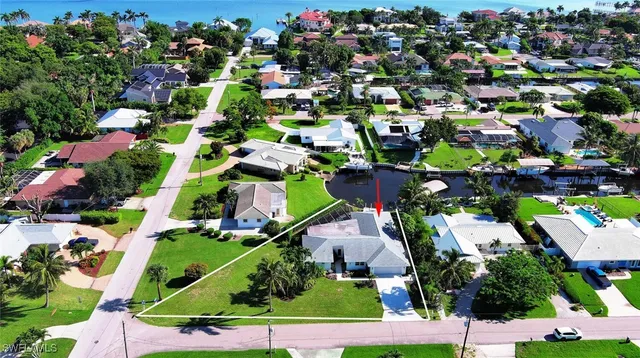 a kitchen with a table chairs stove and wooden floor