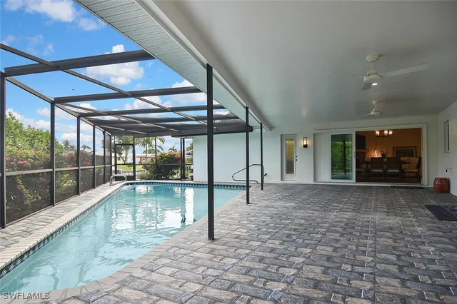 a kitchen with a sink a refrigerator and wooden floor