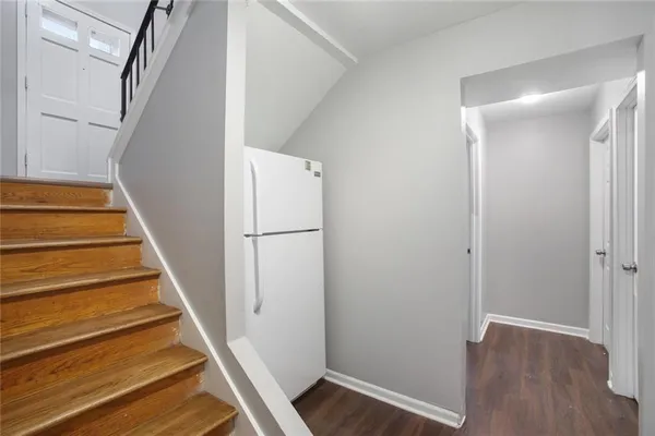 a view of entryway with wooden floor and stairs