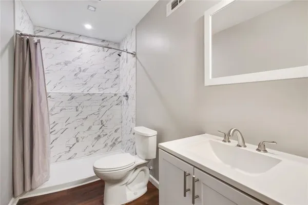 a bathroom with a sink toilet and shower