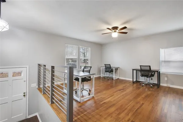 a view of a livingroom with furniture and a ceiling fan