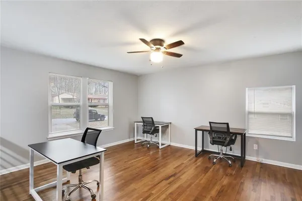 a workspace with furniture window and wooden floor
