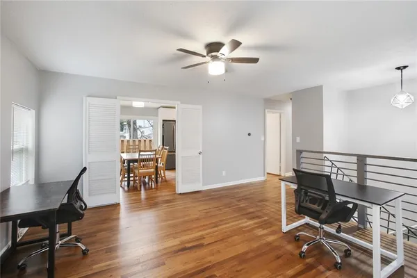 a view of a workspace with furniture and wooden floor
