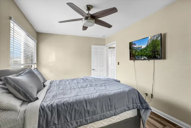 a bedroom with a bed and a flat screen tv