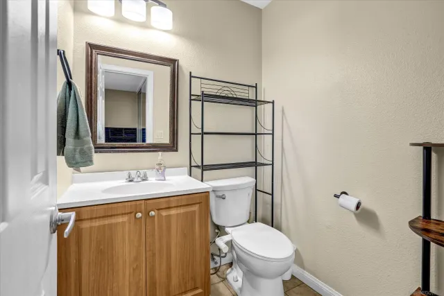 a bathroom with a sink toilet and mirror