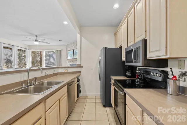 a kitchen that has a sink cabinets counter space and stainless steel appliances