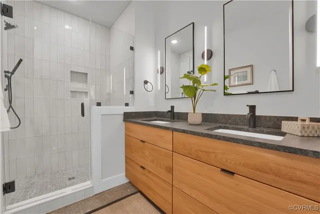 a bathroom with a granite countertop sink mirror and double