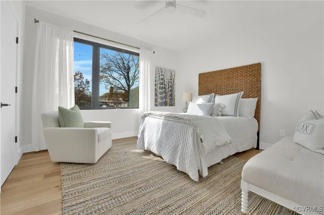a spacious bedroom with a bed and a large window
