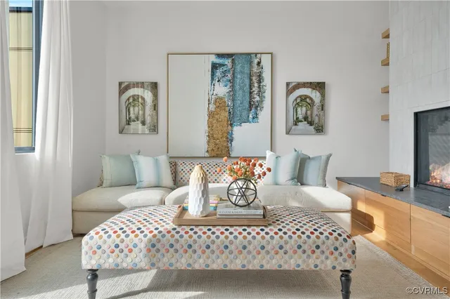 a living room with furniture and painting on the wall