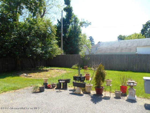 7-a-b Ellis Street Freehold, NJ 07728 - Photo 23 of 23 a view of a backyard with plants and a fire pit