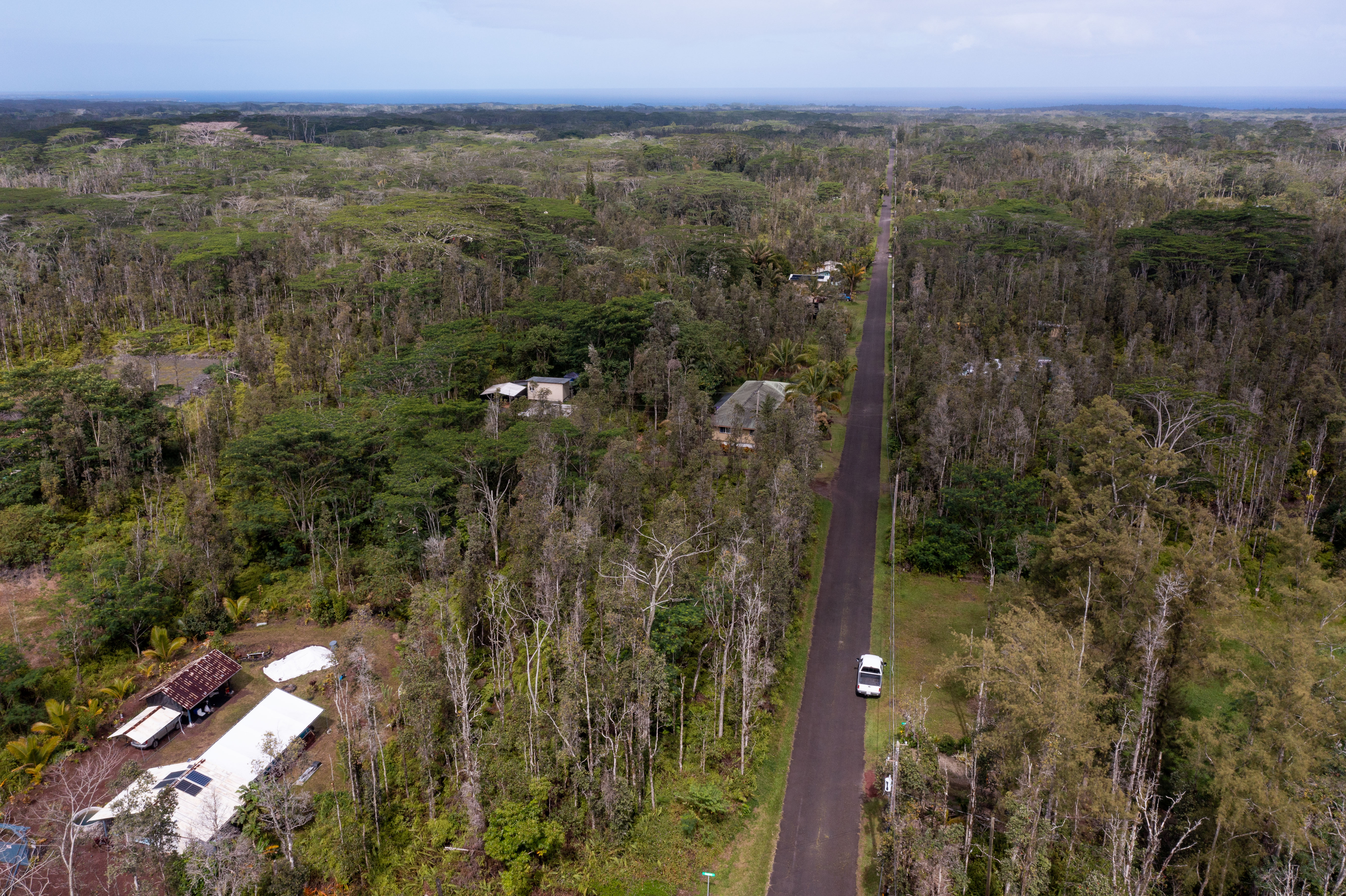 44 Seaview Road Pahoa, HI 96778 - Photo 4 of 22 a view of a city with lush green forest