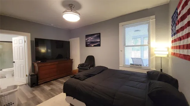 a bedroom with a bed and a large window