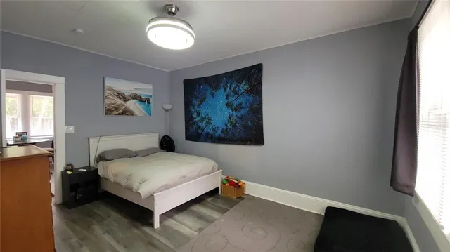 a view of room with window and wooden floor