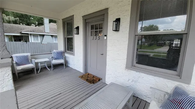a living room with a couch and a table with wooden floor