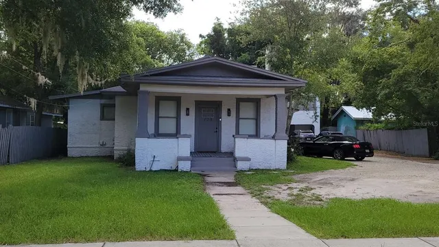a front view of house with a garden