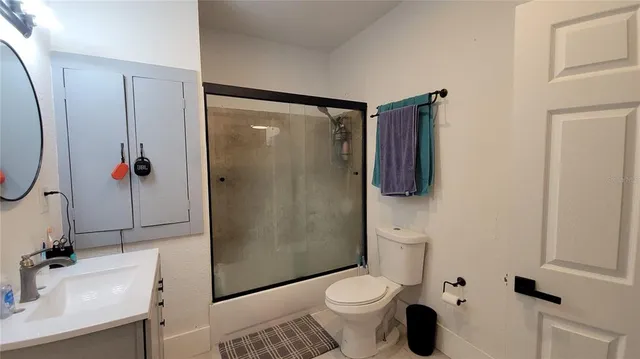 a bathroom with a sink toilet and shower