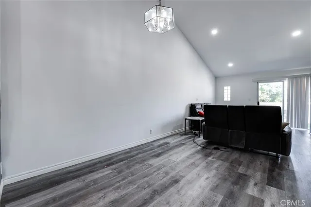 a view of workspace with wooden floor and a window