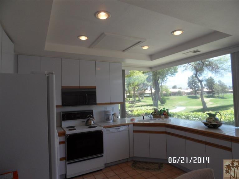 27 Oak Tree Drive Rancho Mirage, CA 92270 - Photo 11 of 21 a kitchen with stove a sink and a microwave