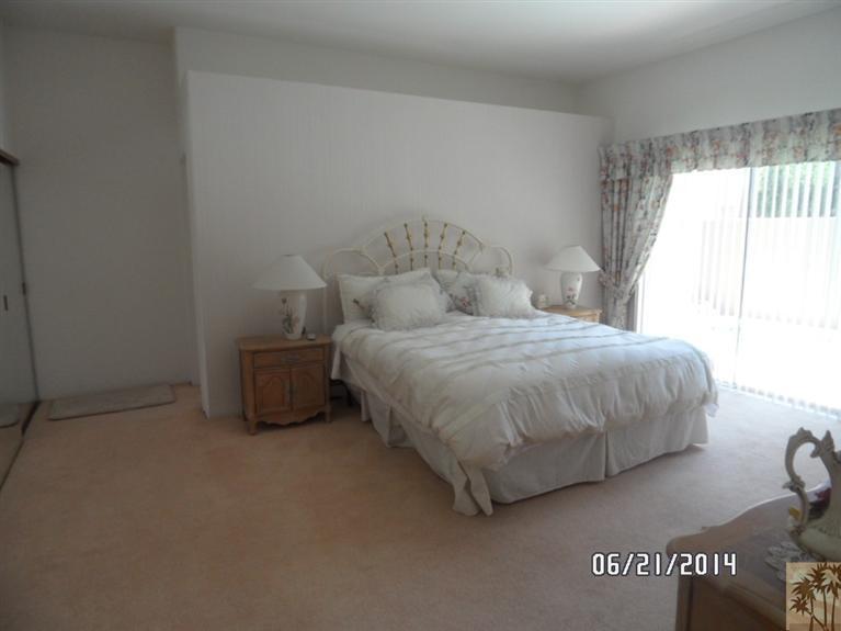 27 Oak Tree Drive Rancho Mirage, CA 92270 - Photo 12 of 21 a bedroom with a bed and a window