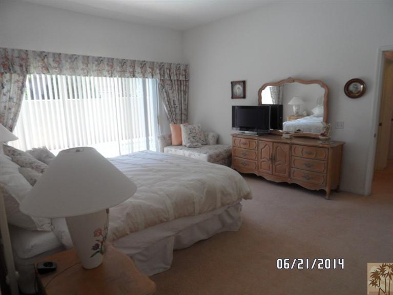 27 Oak Tree Drive Rancho Mirage, CA 92270 - Photo 13 of 21 a bedroom with a bed and window