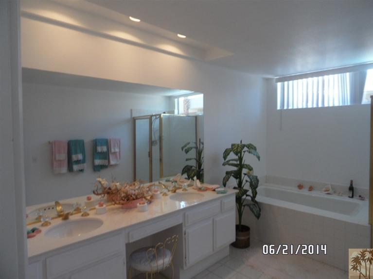 27 Oak Tree Drive Rancho Mirage, CA 92270 - Photo 14 of 21 a bathroom with a tub sink and mirror