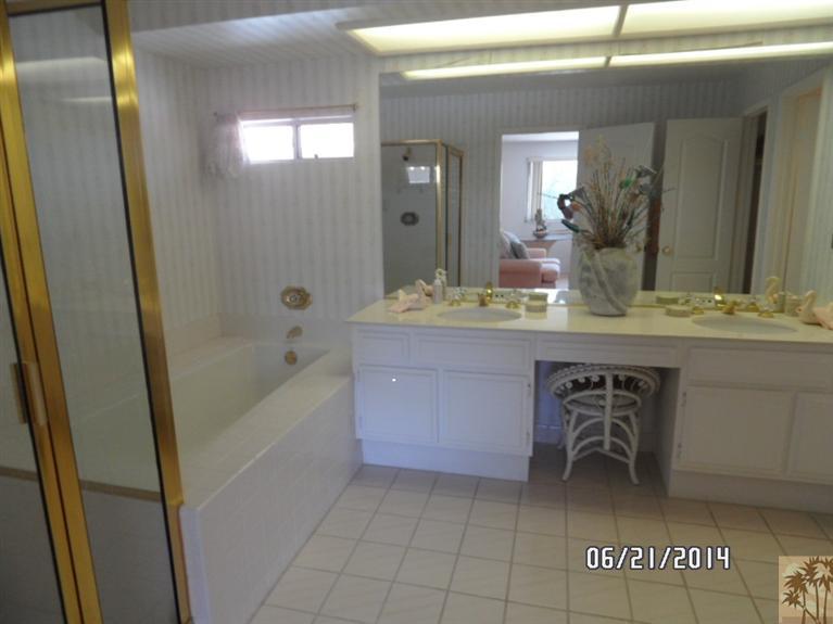 27 Oak Tree Drive Rancho Mirage, CA 92270 - Photo 16 of 21 a bathroom with a sink a mirror and a bathtub