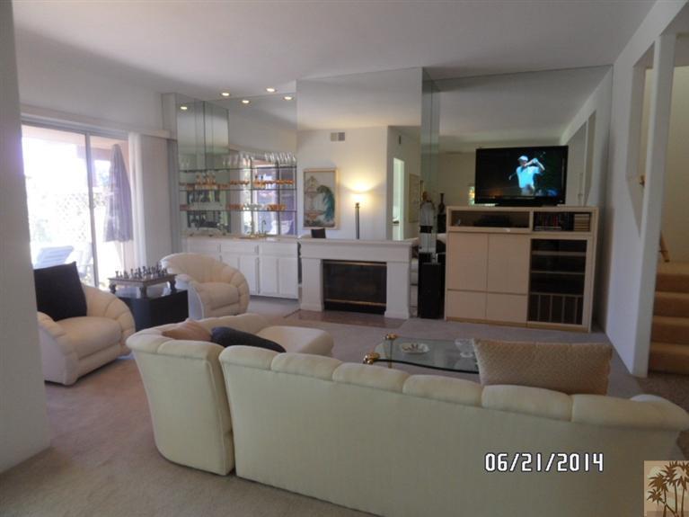 27 Oak Tree Drive Rancho Mirage, CA 92270 - Photo 18 of 21 a living room with furniture a flat screen tv and a fireplace