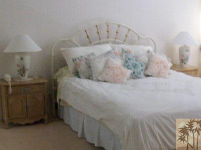 27 Oak Tree Drive Rancho Mirage, CA 92270 - Photo 5 of 21 a large bed sitting in a room next to a lamp