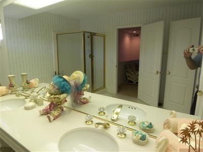 27 Oak Tree Drive Rancho Mirage, CA 92270 - Photo 7 of 21 a bathroom with a sink mirror and shower