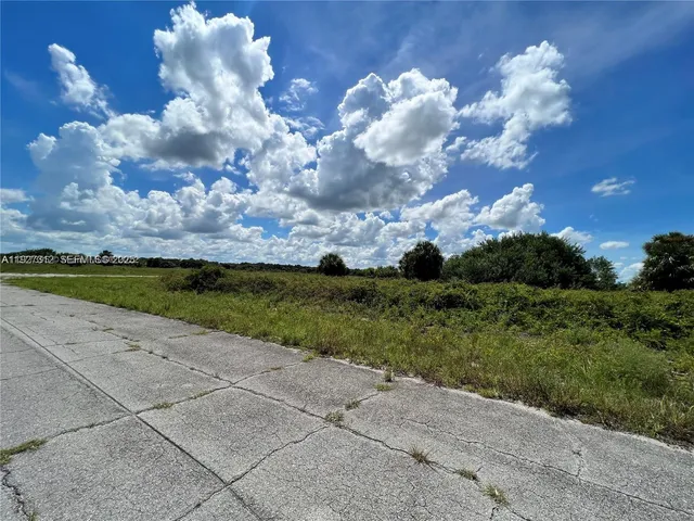 a view of a lake in front of a building with a yard