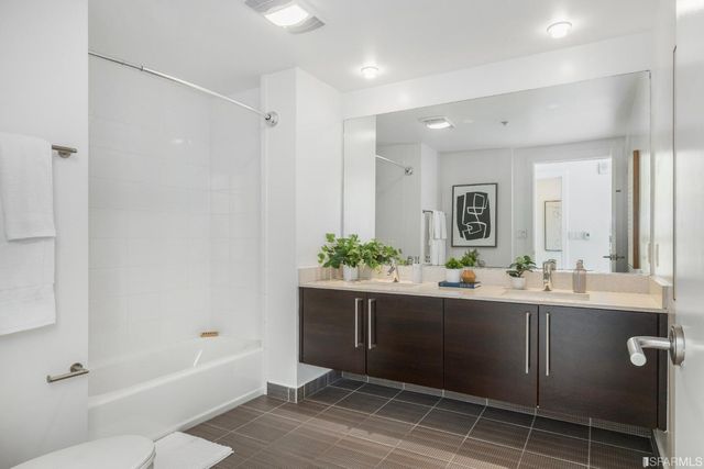 a bedroom with a large window and a bed