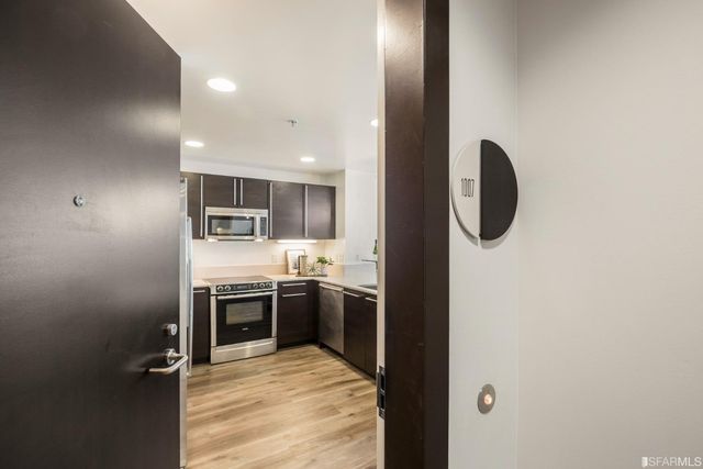 a kitchen with kitchen island sink cabinets and stainless steel appliances