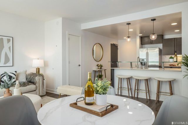 a kitchen with stainless steel appliances granite countertop a sink refrigerator and microwave