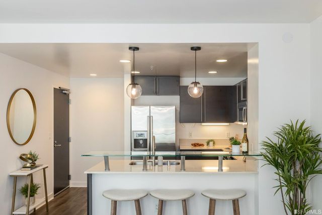 a kitchen with stainless steel appliances granite countertop a sink stove and refrigerator