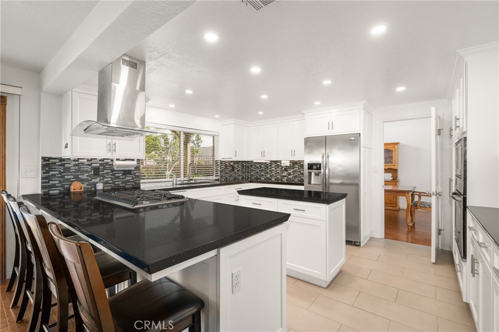 3250 North Geronimo Avenue Simi Valley, CA 93063 - Photo 21 of 47 a kitchen with a center island appliances and cabinets