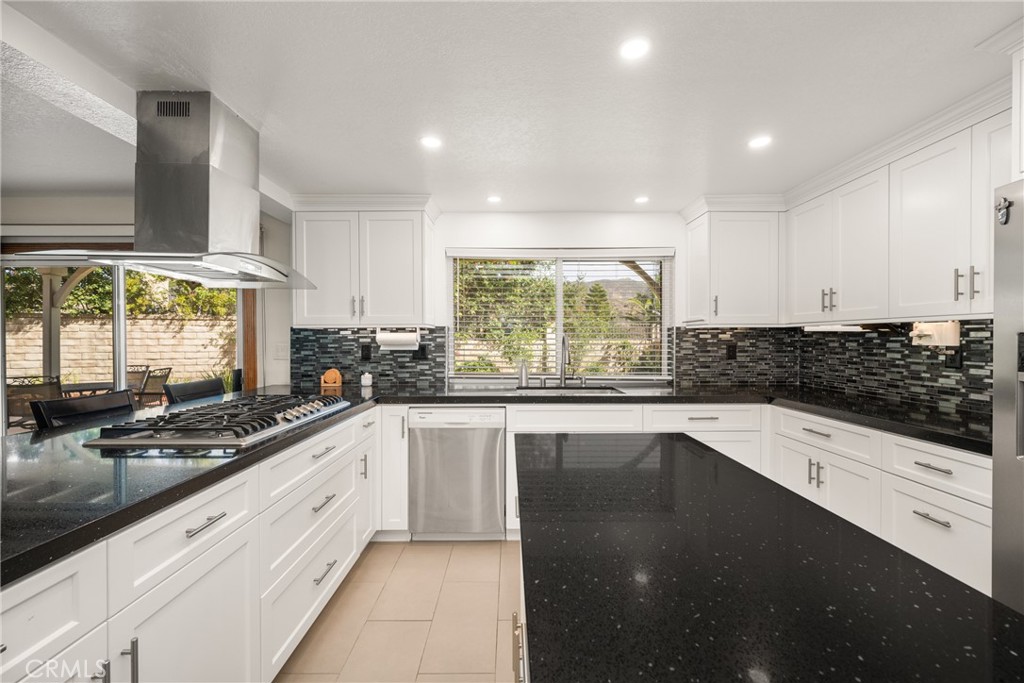 3250 North Geronimo Avenue Simi Valley, CA 93063 - Photo 23 of 47 a kitchen with stainless steel appliances a sink stove and cabinets