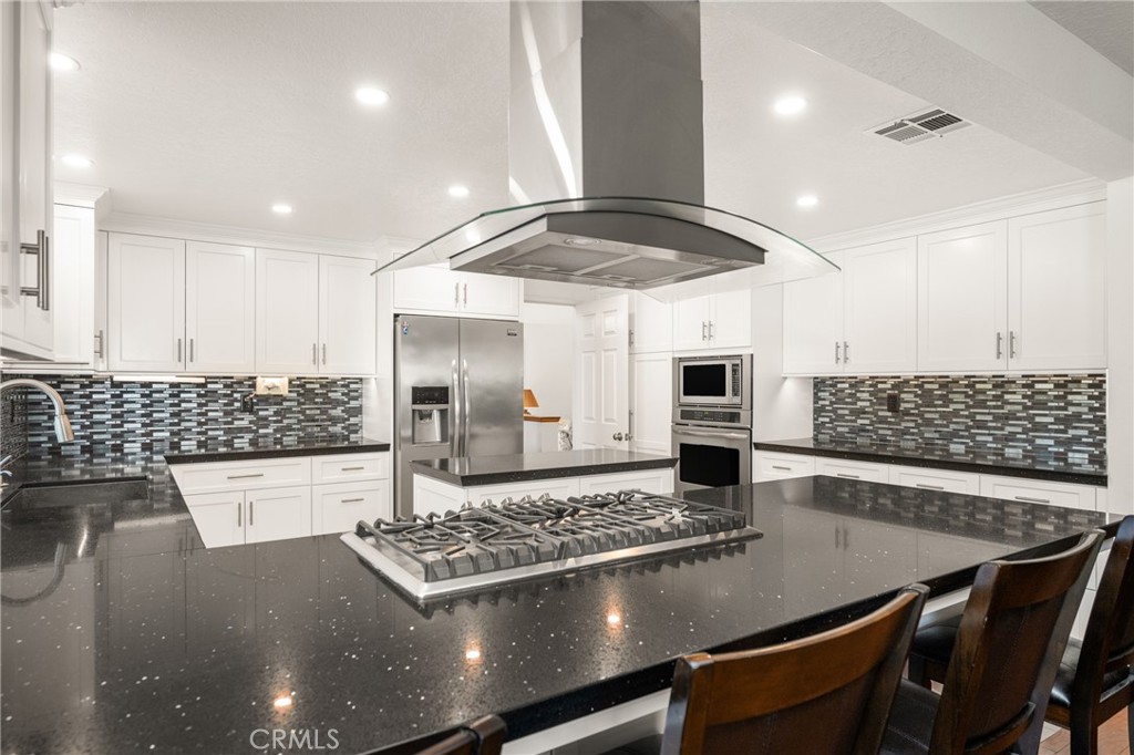 3250 North Geronimo Avenue Simi Valley, CA 93063 - Photo 25 of 47 a living room with stainless steel appliances kitchen island a stove and a sink