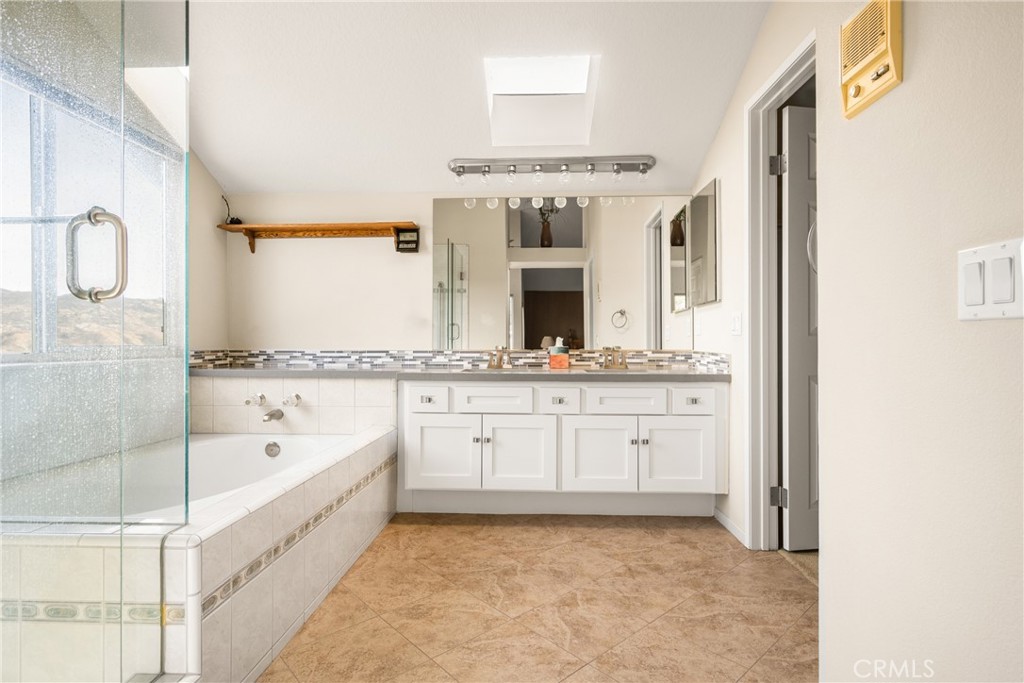 3250 North Geronimo Avenue Simi Valley, CA 93063 - Photo 39 of 47 a spacious bathroom with a granite countertop sink mirror and bathtub