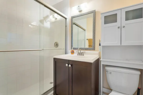 a bathroom with a sink a toilet and a mirror