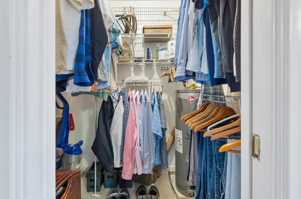 a view of walk in closet with clothes