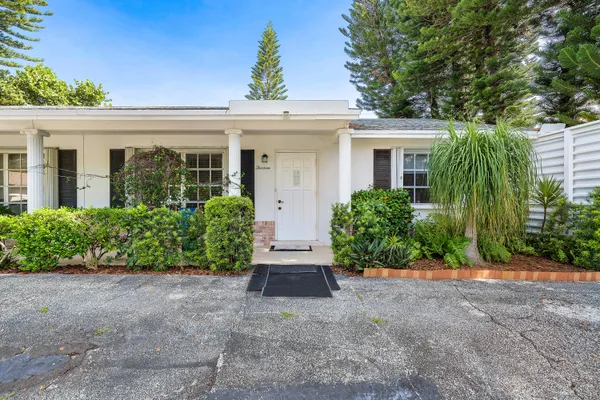 front view of a house with potted plants