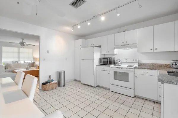 a kitchen with a sink window and cabinets