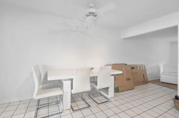 a living room with a chair and white walls