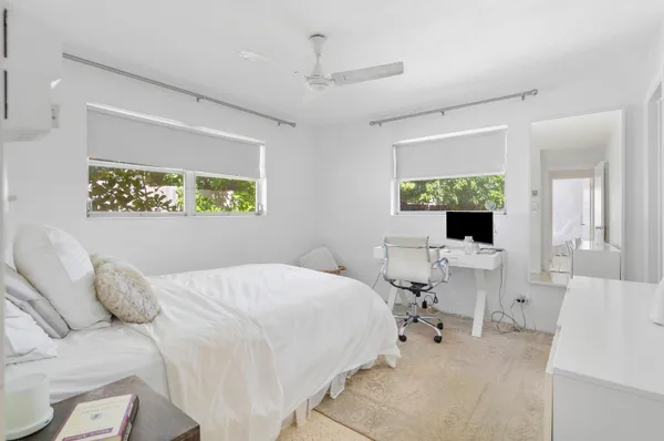 a bedroom with a bed and a large window