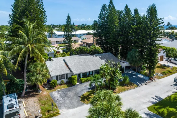 an aerial view of a house with a yard basket ball court and outdoor seating