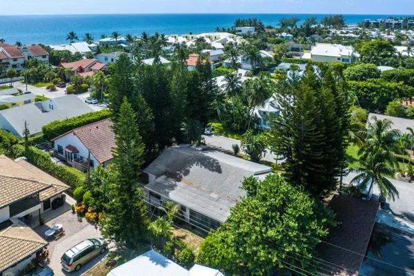 an aerial view of a house with a yard and garden