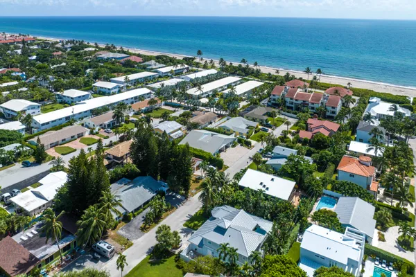 an aerial view of residential houses with outdoor space and street view